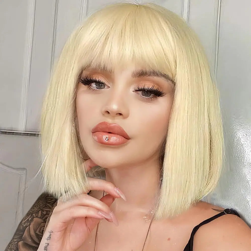Person with a blonde bob wig posing against a neutral background